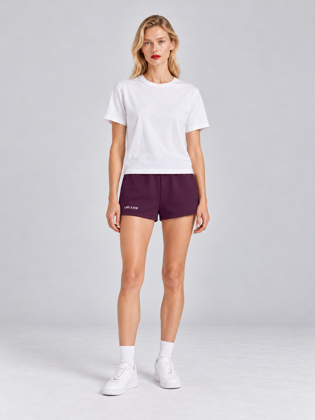 Model wearing Lane & Row Leisure Short Fleece in Black Cherry
